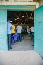 open door to a church with a view of parishioners in Africa 