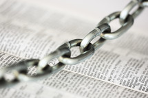 chain on the pages of a Bible 