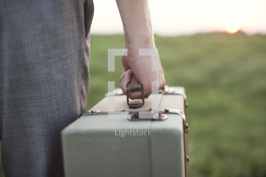 man carrying a suitcase 