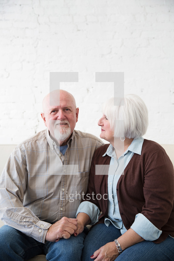 a happy, loving elderly couple holding hands 
