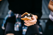 a woman eating s'mores 