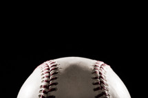 a baseball against a black background 