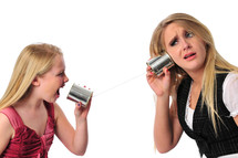 Mother and daughter talking on tin can phones.