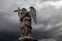 angel statue holding a cross 