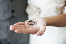 bride holding rings in her hand 