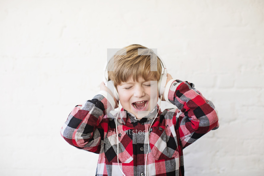 a boy child wearing headphones 