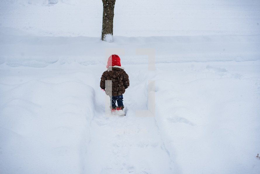 toddler playing in snow 