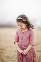 Little girl smiling in a foggy field