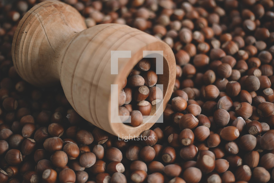 Hazelnuts in a wooden bowl on rustic background