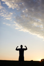 silhouette of a man showing his muscles 