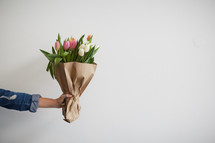 arm holding out a bouquet of flowers 