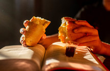 breaking bread over an open Bible 