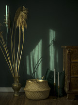 basket and brass vase decorations in a green room 