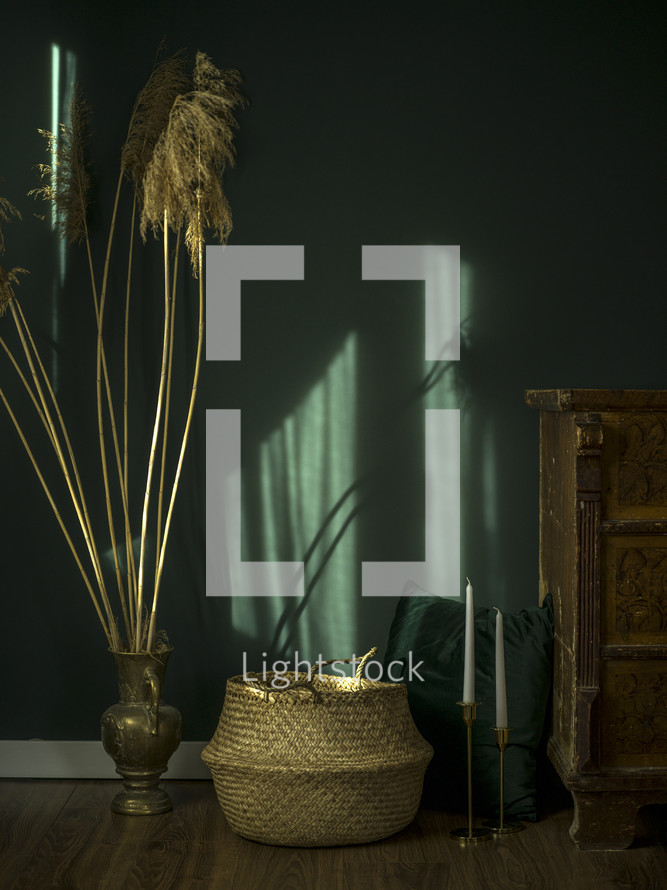 basket and brass vase decorations in a green room 