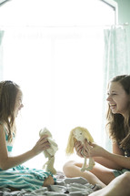 sisters playing with dolls and stuffed animals 