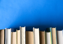 books in a row on a blue background.