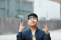 young man showing peace signs 