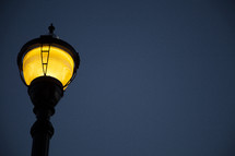 view of lit lamppost from below 