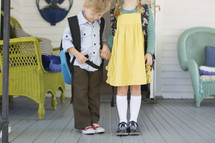 brother and sister holding hands on the first day of school 
