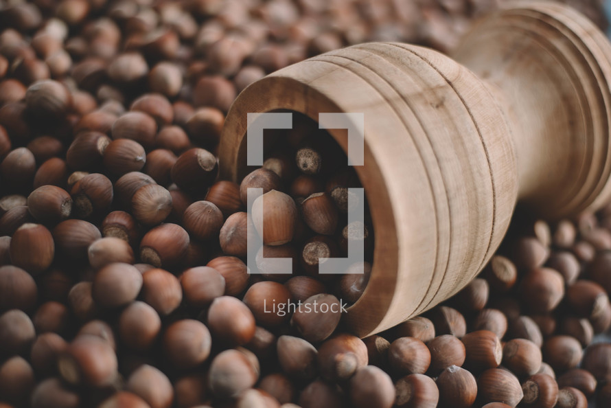 Hazelnuts in a wooden bowl on rustic background