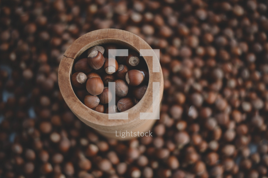 Hazelnuts in a wooden bowl on rustic background