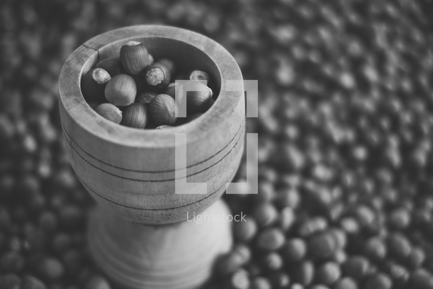 Hazelnuts in a wooden bowl on rustic background