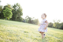 toddler girl running in grass 