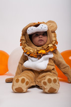 a toddler boy in a lion Halloween costume 