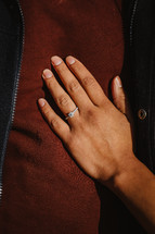 Close up of a woman's hand with an engagement ring on.