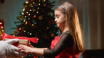 Young girl receiving present from Santa Claus 