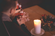 a man praying at a table at Christmas 