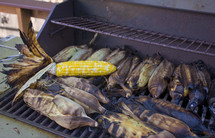 cooking corn husks on the grill 