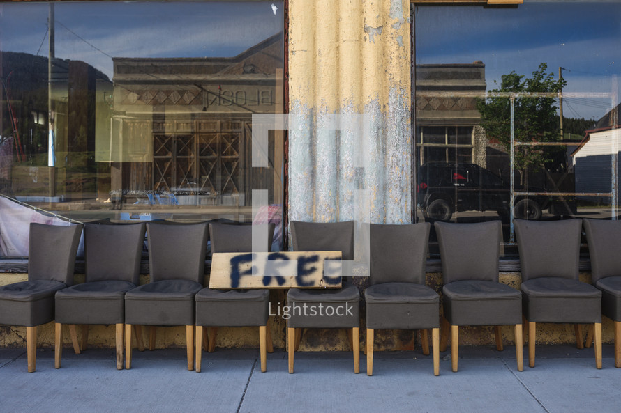 a row of chairs for free outside a demolished building