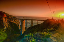 bridge over a ravine and sunset over the ocean 