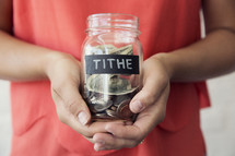 woman holding a tithe jar 