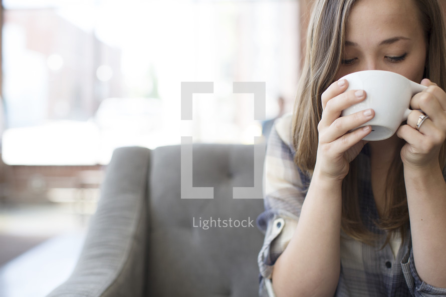 woman drinking a cup of coffee 