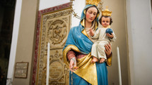The Madonna with baby Jesus in her arms statue of a church
