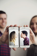 kissing couple on cellphone screens