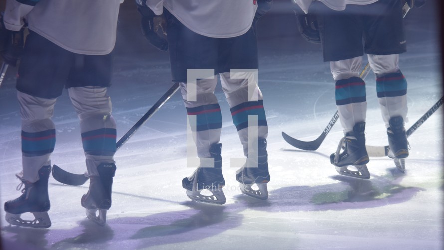 hockey players under spotlights on the ice 