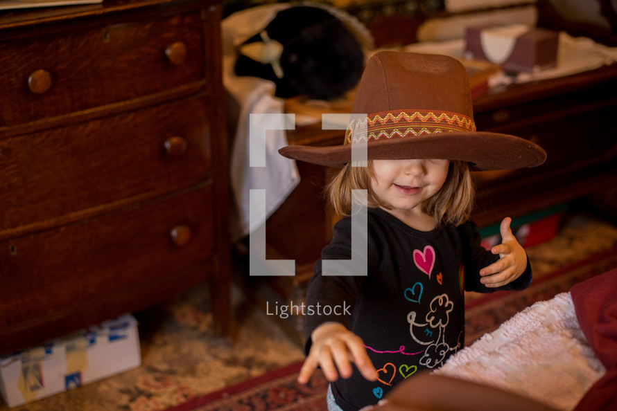 toddler girl in a cowboy hat 