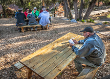 discussions at a picnic table during a men's retreat 