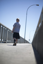 a boy walking on a pier 