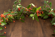 a wreath of holly on wood 