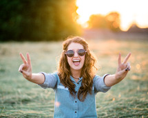 teen girl showing peace signs 
