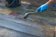 a man staining a table 