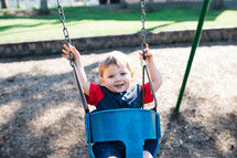 toddler swinging on a swing set 