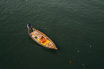 woman on boat crossing river in Dhaka, bangladesh