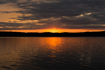 sunset in the horizon over a lake 