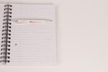 a pen on a blank notebook 