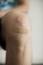 a bandage on a man's knee